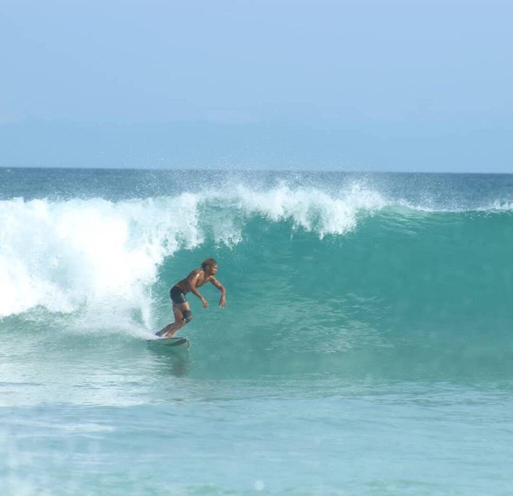 Surfer riding a clean left-hand wave in Boa Vista, Cape Verde