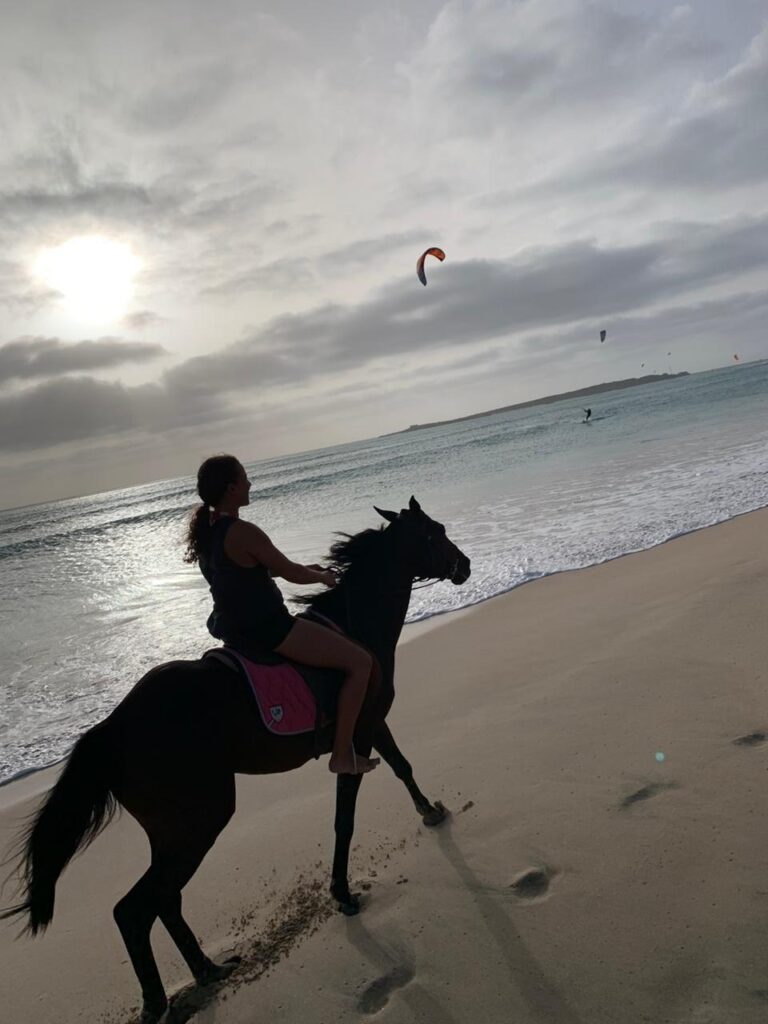 Horseback riding on the beach at sunset with kitesurfers in Boa Vista
