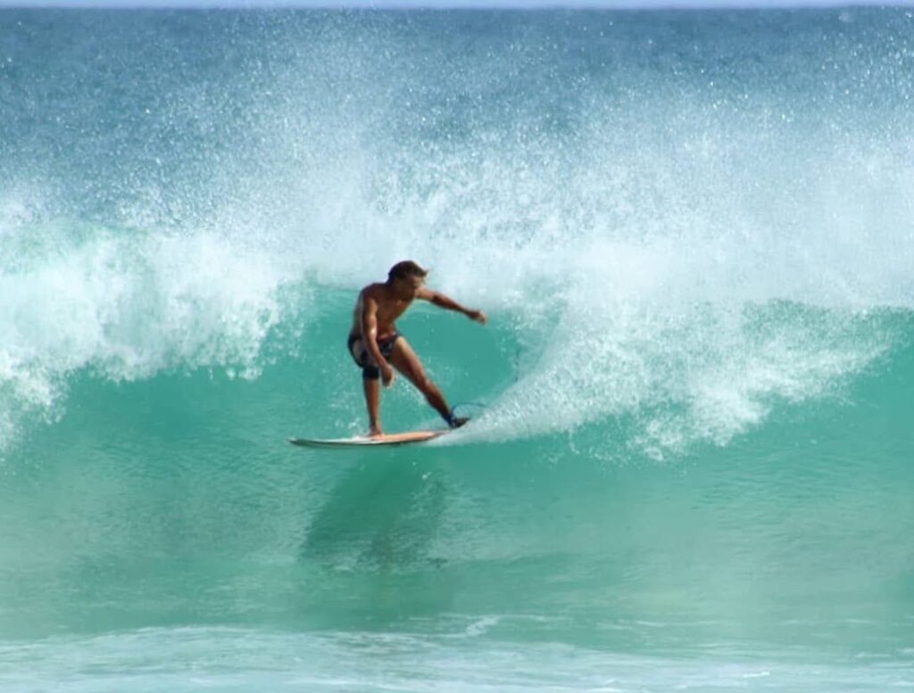 Advanced surfer performing on a clean wave during a surf session in Boa Vista