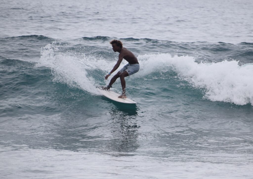 Intermediate to advanced surfer riding a faster wave in Boa Vista, Cape Verde