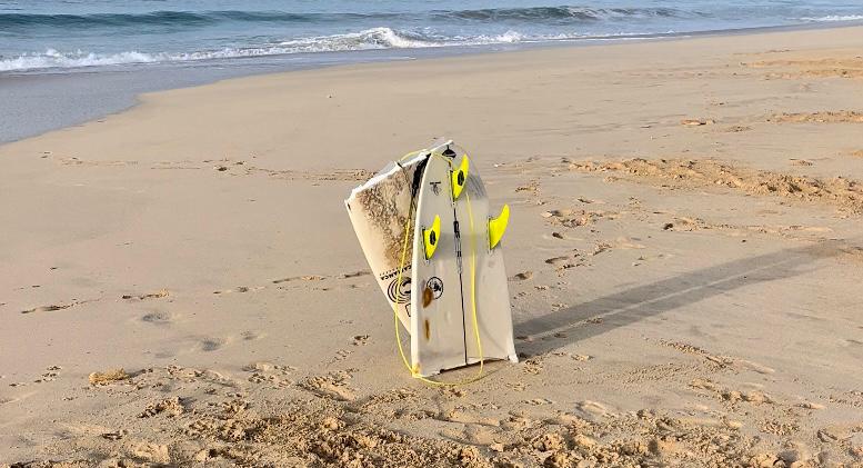Surfboard snapped in half on a beach in Boa Vista